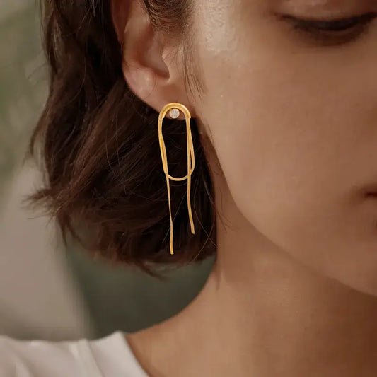 Close-up of zircon tassel drop earrings showing sparkling zircon inlay