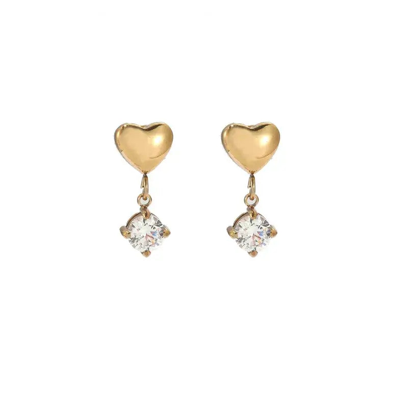 Heart-shaped gold drop earrings close-up view