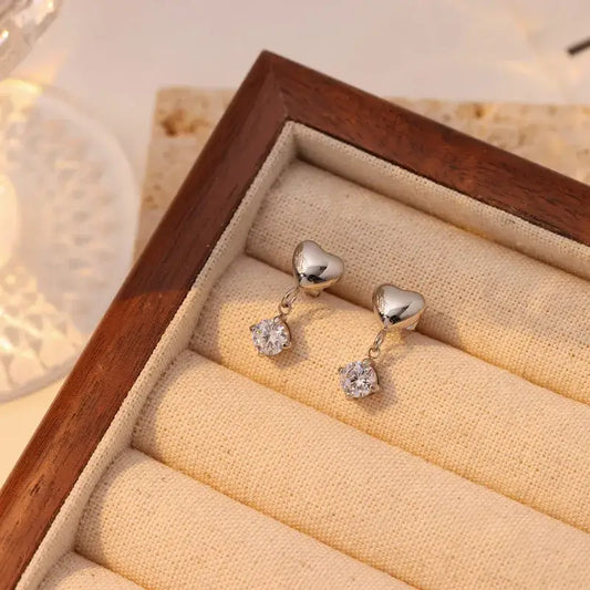 Heart-shaped gold drop earrings with zircon inlays