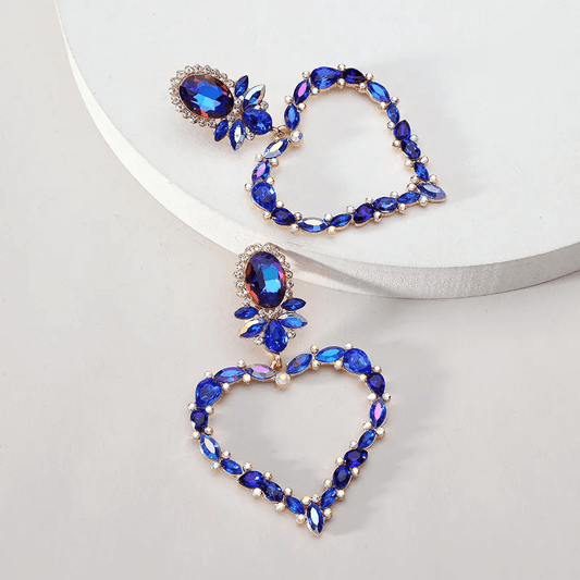 Luxurious heart-shaped drop earrings with blue glass inlays and alloy base, perfect for elegant jewelry statement.