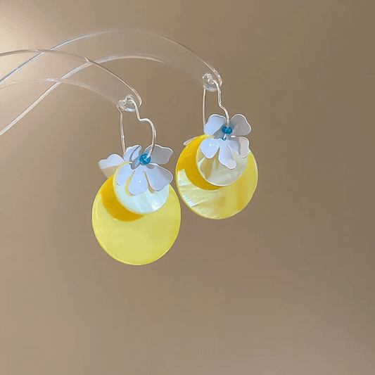 Shell tassel drop earrings featuring yellow and white floral design, stylish boho chic accessory.
