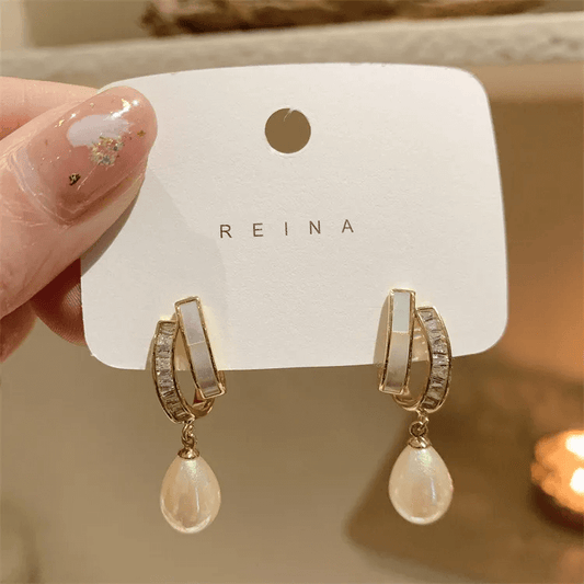 Elegant square heart bow earrings with rhinestones and pearls on display, perfect jewelry for women.