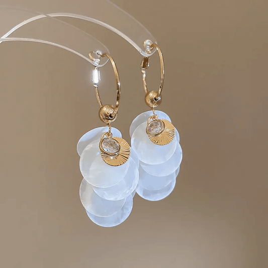 Shell tassel earrings featuring geometric shell design and soft cloth tassels for a stylish look.