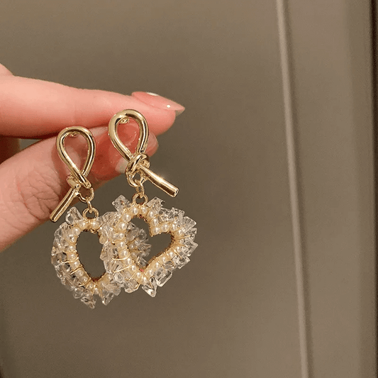 Geometric heart bow knot earrings featuring clear crystals and gold accents, perfect for stylish occasions.