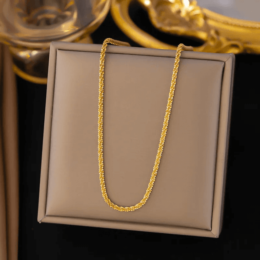 Gold plated stainless steel necklace displayed elegantly on a jewelry box.