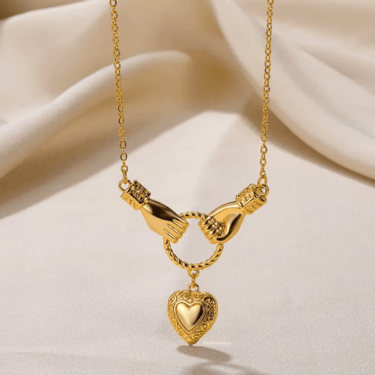 Gold Plated Heart Pendant Necklace – Titanium Steel, Waterproof design featuring intertwined hands and a heart charm.