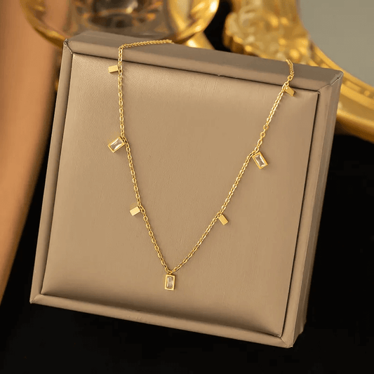 18K gold plated pendant necklace displayed elegantly on a soft beige jewelry box.