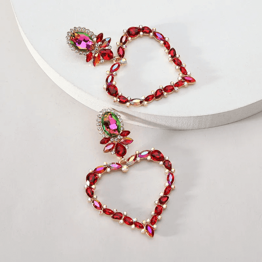 Shiny heart inlay drop earrings featuring vibrant red stones and elegant design for a romantic look.