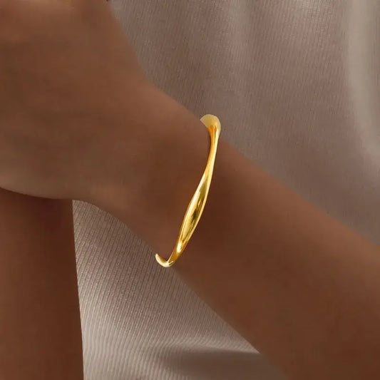 Close-up of gold-plated classic bangle showing polished 18K finish