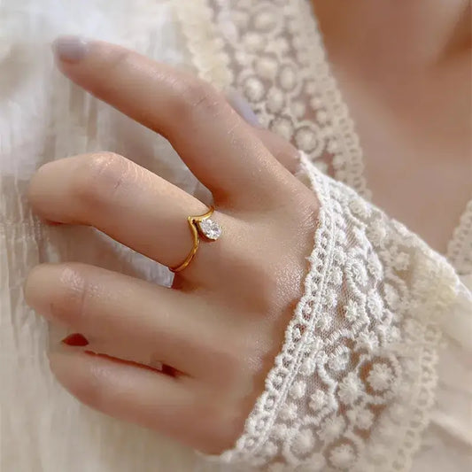 Close-up of minimal zircon titanium ring with sparkling zircon inlay