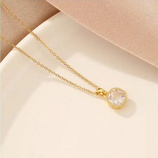 Close-up of square pendant necklace showing polished stainless steel pendant