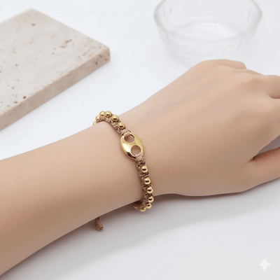 18K gold plated charm bracelet worn on a wrist, featuring charming design elements and elegant bead details.