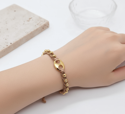 18K gold plated charm bracelet worn on a wrist, featuring charming design elements and elegant bead details.