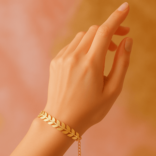 Close-up of gold-plated leaf bracelet showing detailed leaf pattern