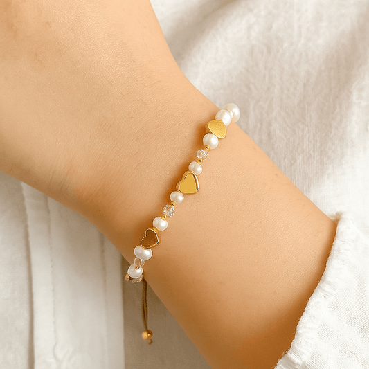 Close-up of heart charm bracelet showing detailed heart shapes and beads