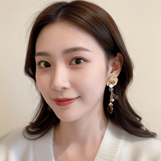 Heart Bow Knot Earrings – Geometric Pearl & Zircon Design worn by a model with subtle makeup and a white sweater.