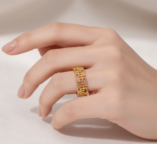 Gold plated geometric open ring displayed on a hand, showcasing its stylish and modern design.