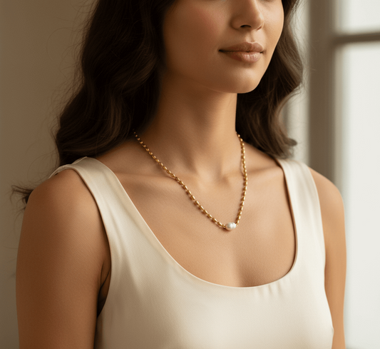 Gold plated pendant necklace waterproof worn by a woman with a classic pendant design in a stylish setting.