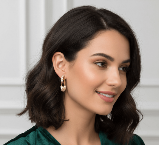 Geometric hairpin stud earrings in 18K gold worn by a woman with a chic hairstyle, showcasing modern style.
