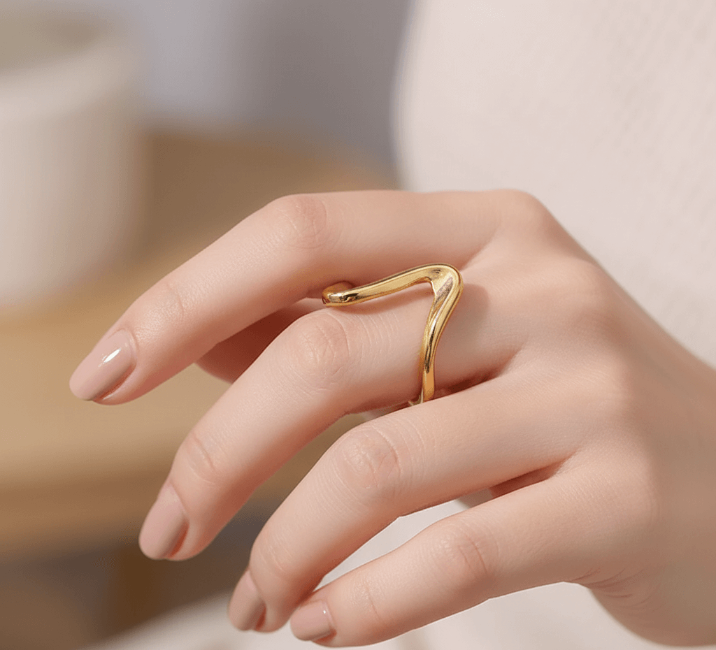 Gold plated geometric ring for women worn on a hand showing a chic and modern design.
