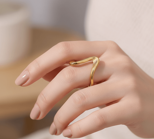 Gold plated geometric ring for women worn on a hand showing a chic and modern design.