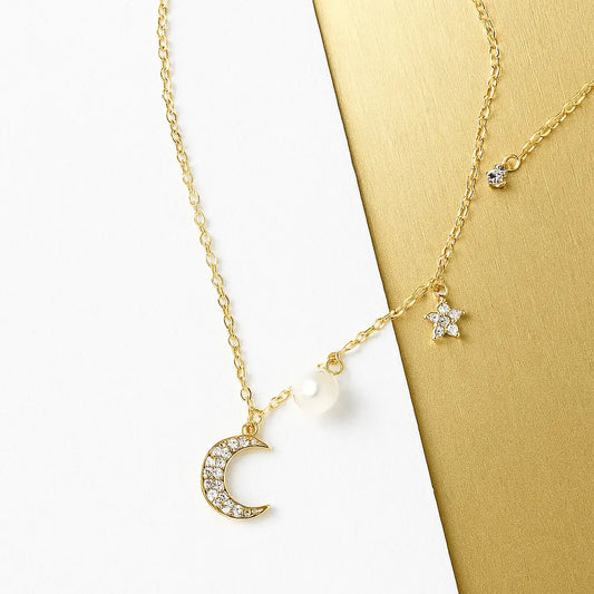 Close-up of Star and Moon Pendant Necklace with gold finish