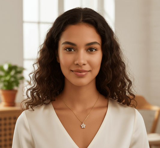 18K gold-plated flower pendant necklace worn by a woman in a light blouse, showcasing elegance in everyday style.