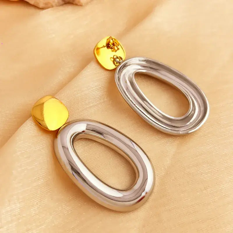 Close-up of stainless steel drop earrings showing hollow details