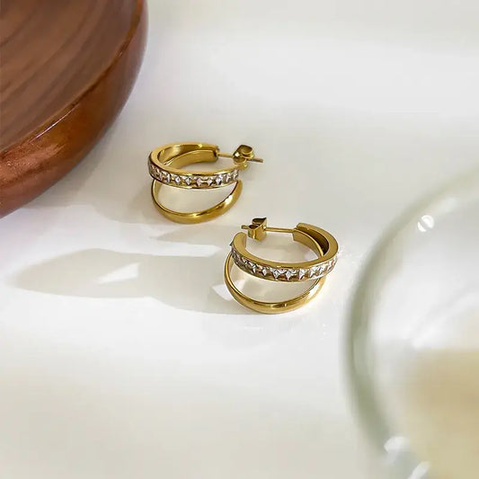 Women’s geometric gold earrings close-up view