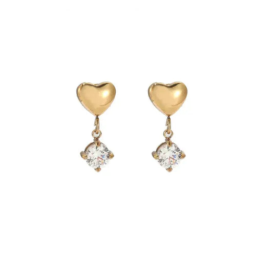 Heart-shaped gold drop earrings close-up view