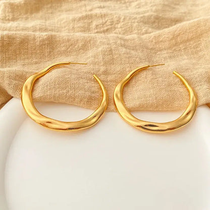 Irregular copper stud earrings in elegant jewelry box packaging