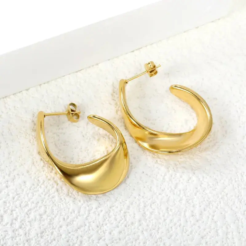 C-shaped stainless steel stud earrings styled with casual and formal outfits