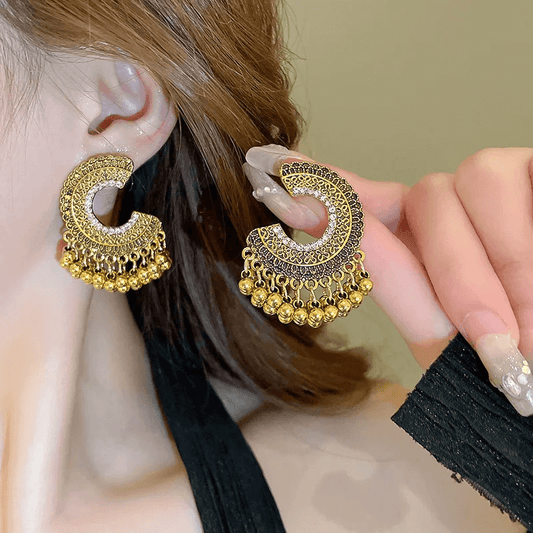 Retro ethnic tassel earrings featuring geometric designs and ornate accents for a fashionable boho look.