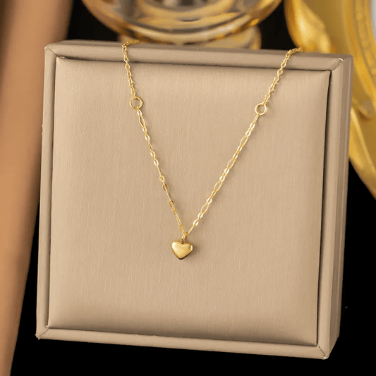 Luxury Gold-plated heart pendant necklace displayed on a jewelry box with elegant background.