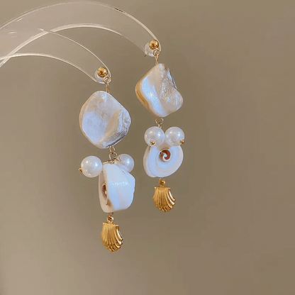 Summer shell tassel earrings featuring a geometric shell design and soft cloth tassels.