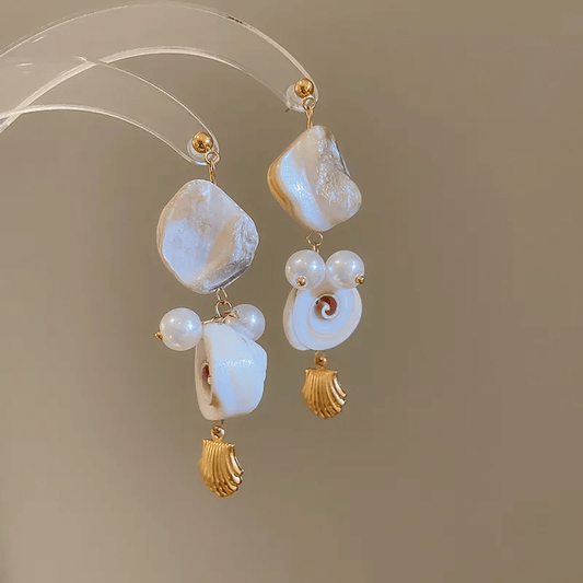 Summer shell tassel earrings featuring a geometric shell design and soft cloth tassels.