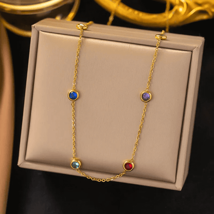18K gold-plated heart pendant necklace displayed on a decorative box with colorful gemstones.
