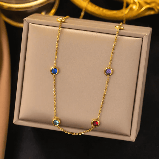18K gold-plated heart pendant necklace displayed on a decorative box with colorful gemstones.