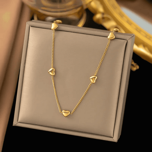 18K gold-plated heart pendant necklace displayed on a jewelry box with heart charms.