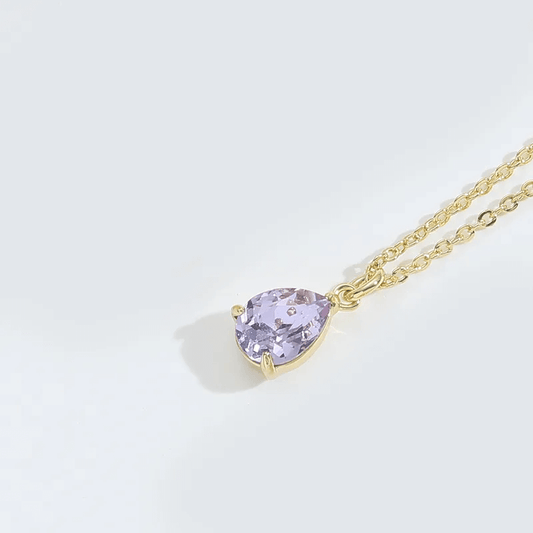 Vintage water drop pendant necklace featuring a lavender stone and gold chain.