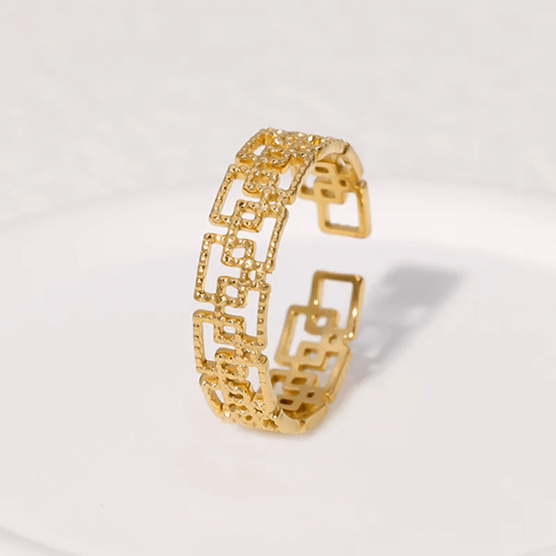 Gold plated geometric open ring with a stylish hollow-out design, ideal for modern women's jewelry.