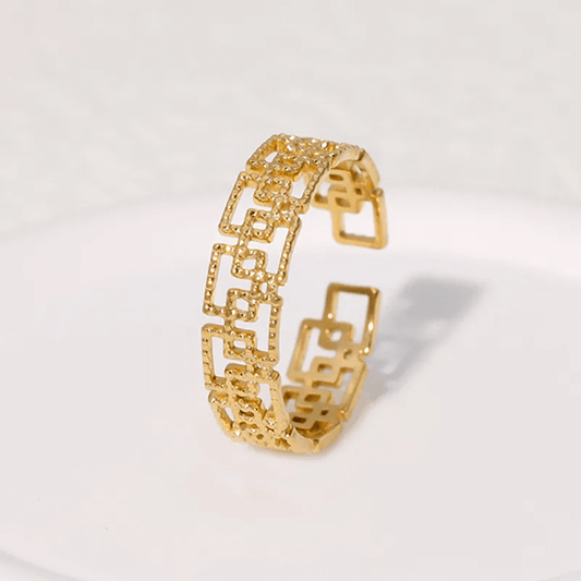 Gold plated geometric open ring with a stylish hollow-out design, ideal for modern women's jewelry.