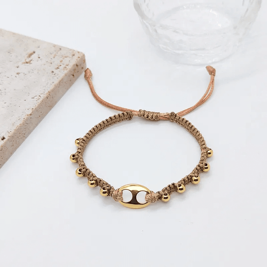 18K gold plated charm bracelet featuring delicate gold bells on a woven cord.