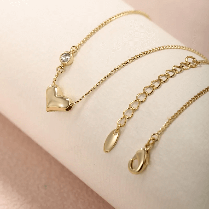 Heart shape gemstone necklace with gold alloy chain and sparkling detail for women.