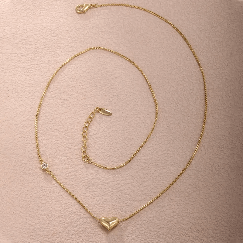 Heart shape gemstone necklace – Gold alloy necklace for women featuring a heart pendant and sparkling gemstone.