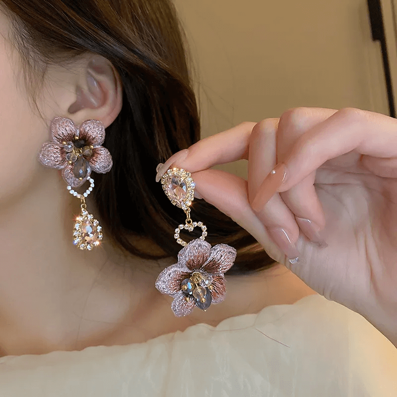 Geometric Bow Knot Earrings – Elegant Pearl & Zircon Design showcased with floral detail and sparkling accents.