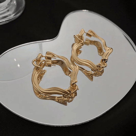 Elegant Earrings – Geometric Flower Design, Polished Finish displayed on a reflective surface.