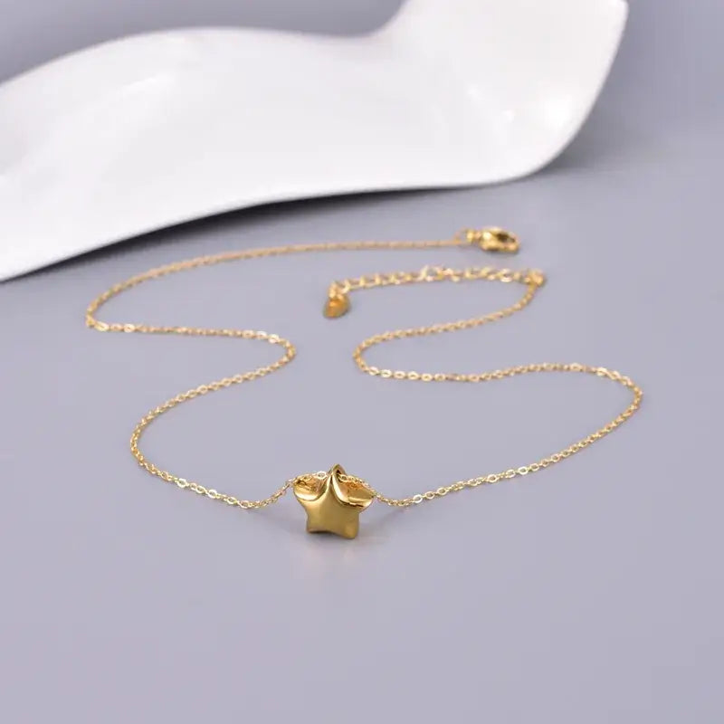Close-up of 18K gold plated solid pendant necklace on model