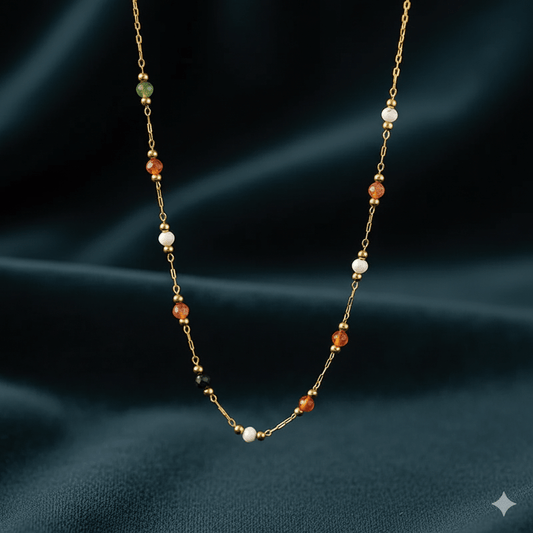 Elegant gold-plated pendant necklace showcased on a dark fabric background, highlighting its stylish design and inlay details.