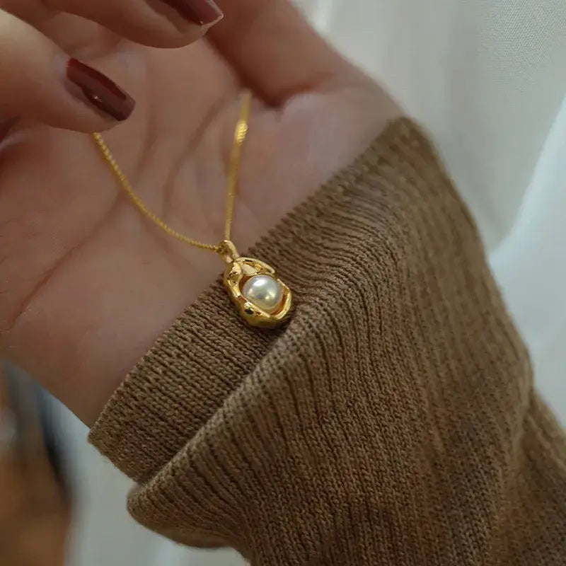 Water droplet pearl pendant necklace displayed on jewelry stand